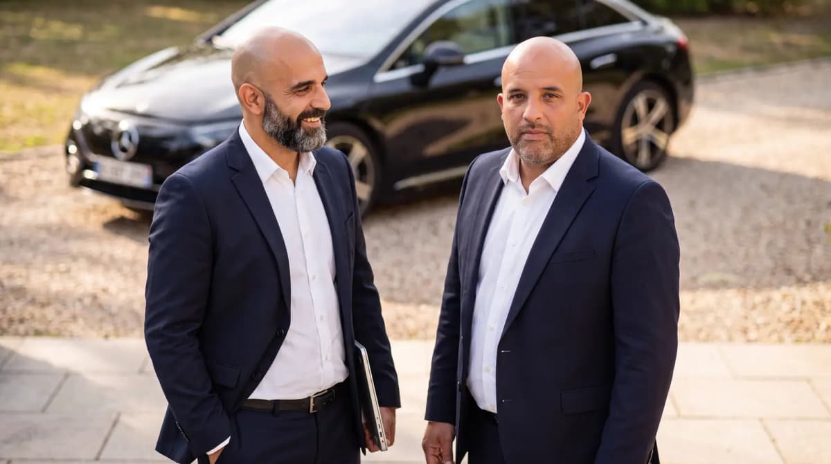 Tarek and Adil Mhira, founders of PrivateDrive, in front of a black Mercedes in Paris